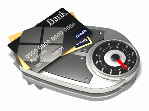 Scale with credit cards illustrating the weight of debt.