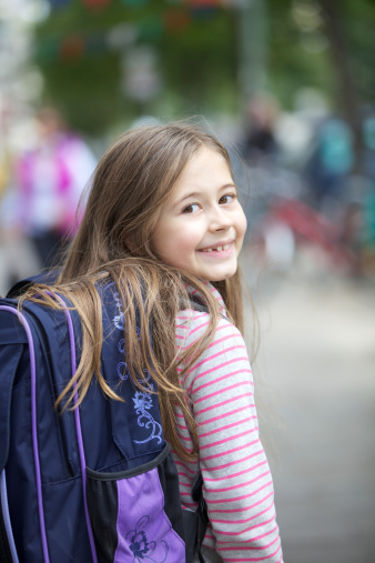 Happy little girl going back to school
