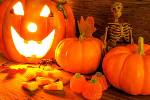Halloween scene with pumpkins and a skeleton.