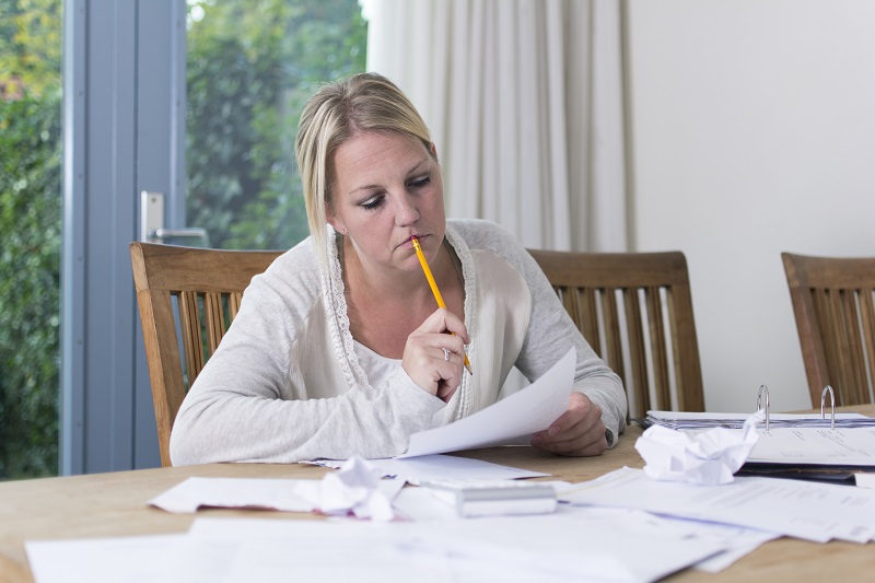 Woman tries to organize finances to help with financial problems